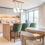 Modern kitchen with stylish dining area and vibrant accents in colour at Avon Bard in Stratford Upon Avon.