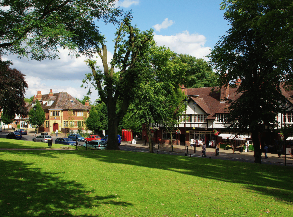 Lush green park with historic buildings.